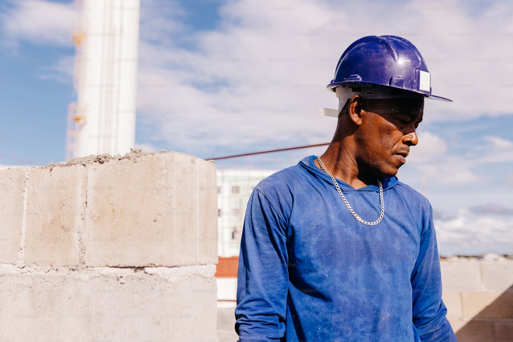 a man wearing a blue shirt and a hard hat