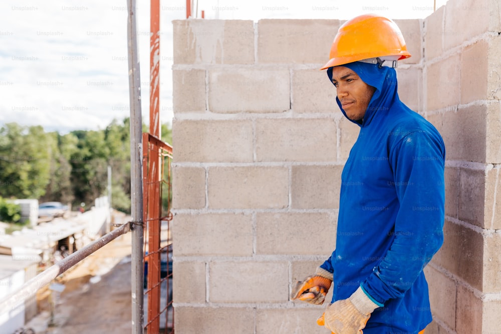 a man wearing a hard hat and a blue jacket