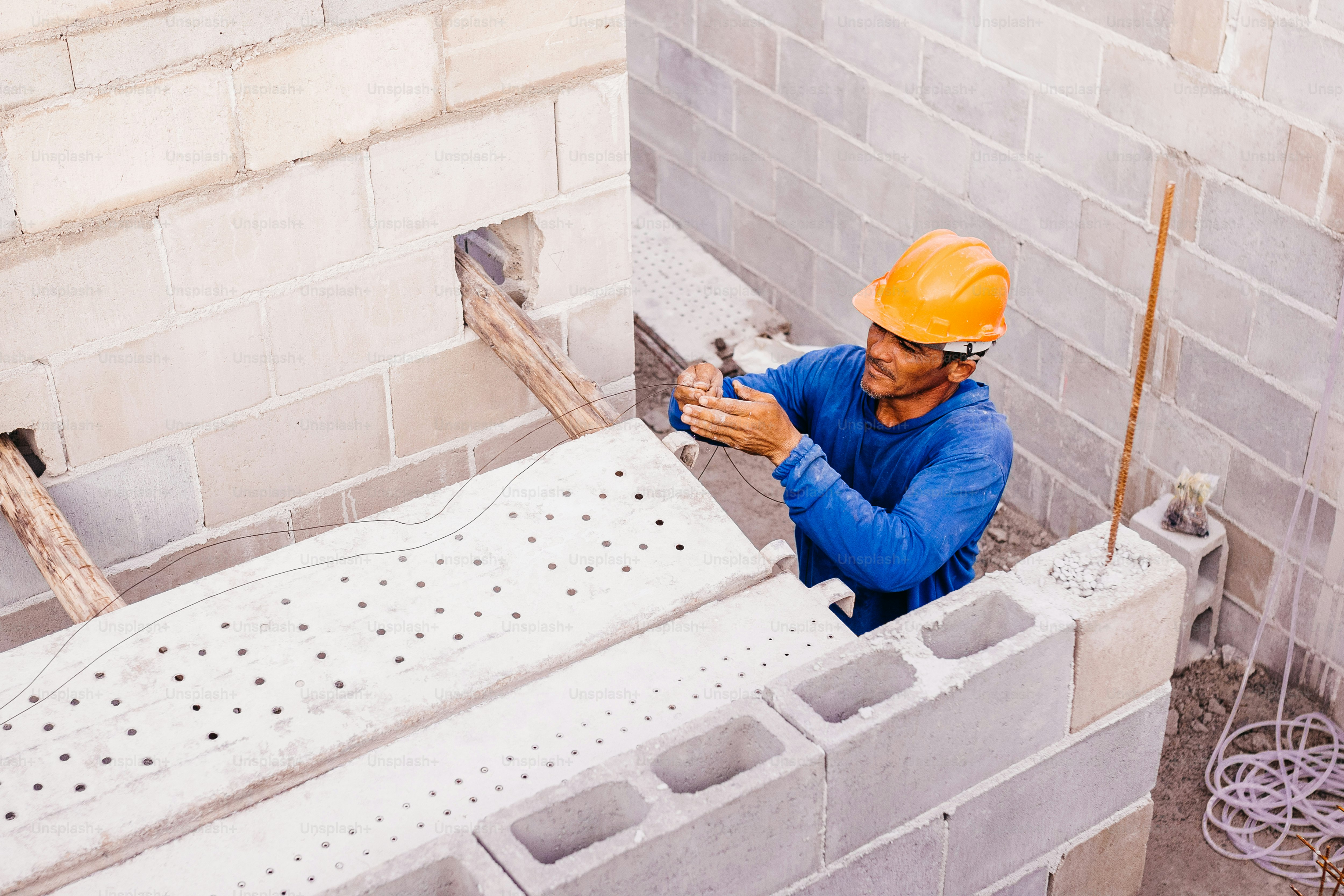 a man in a hard hat is working on a building