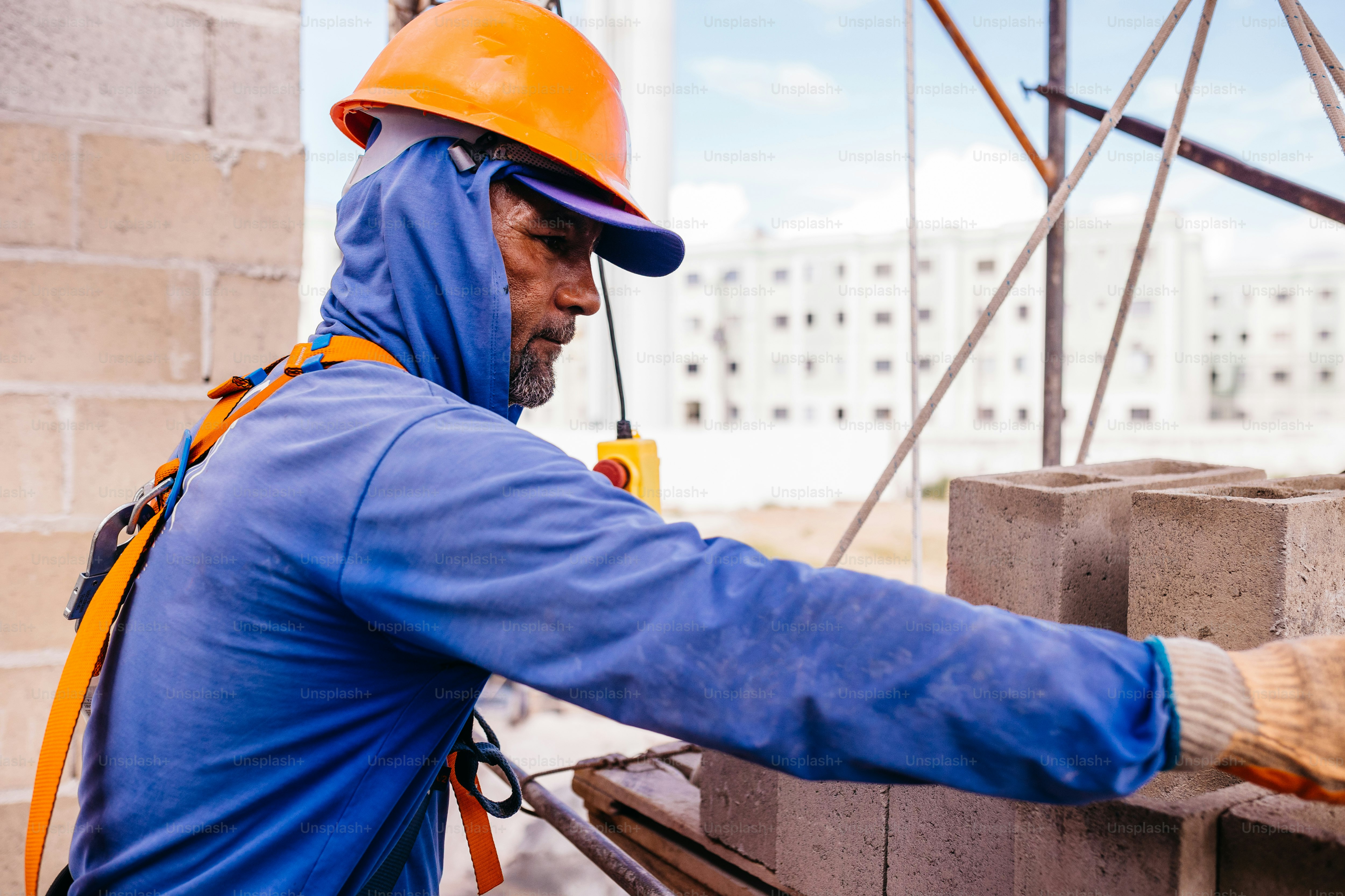 a man wearing a hard hat and a blue jacket