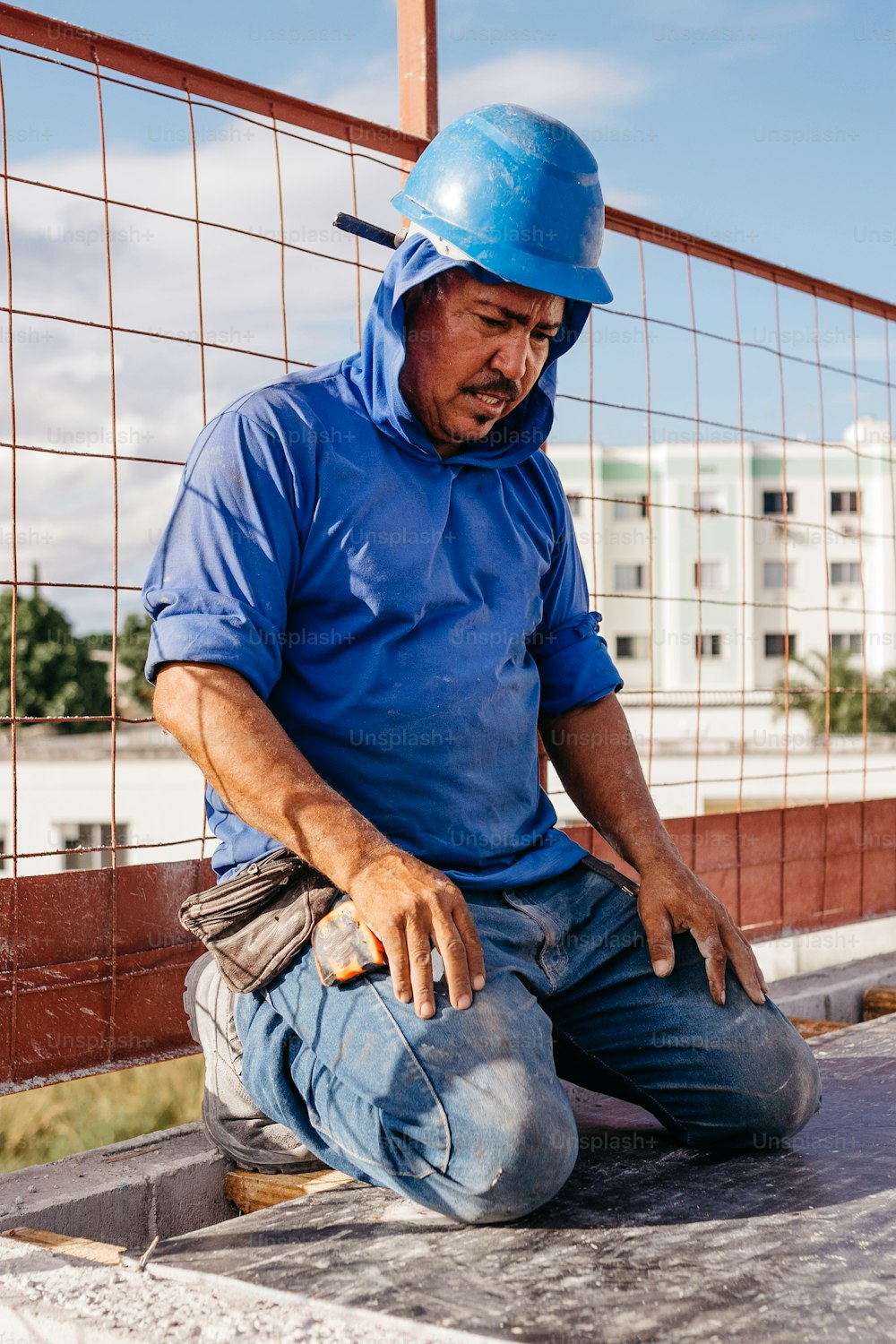 a man in a blue shirt and a blue helmet