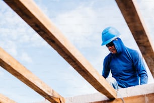 a man wearing a hard hat and a blue jacket