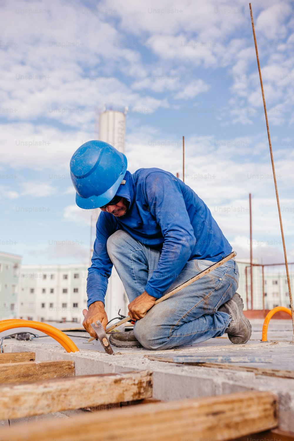 a man in a blue hat working on a building