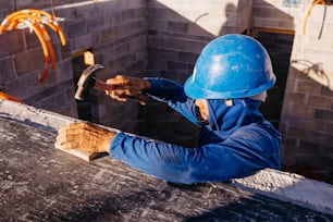 a man in a hard hat working on a building