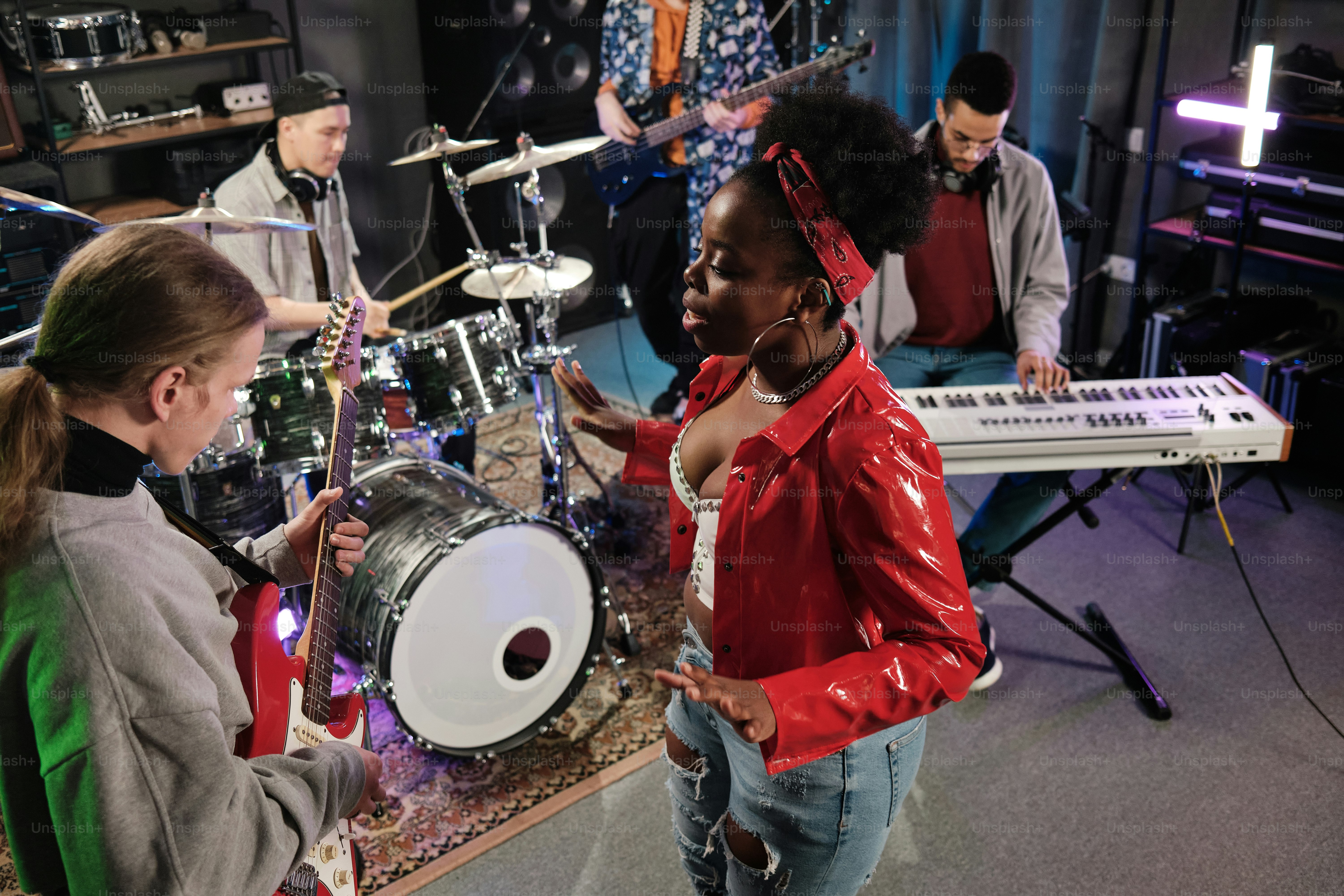 A group of people standing around a musical instrument photo ...