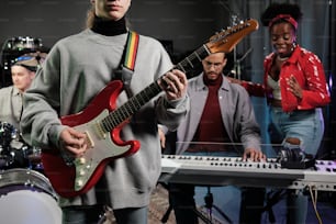 a group of people standing around a musical keyboard