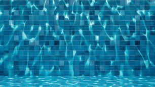 a blue tiled wall with water reflecting on it
