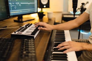 a person sitting at a keyboard in front of a computer