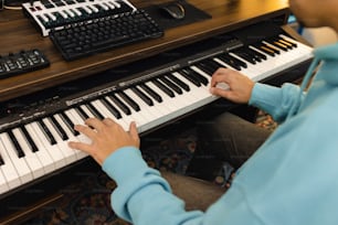 a person sitting at a piano playing a musical instrument