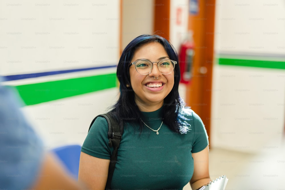 a woman in a green shirt is smiling