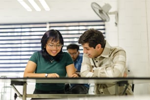 a man and a woman looking at a cell phone