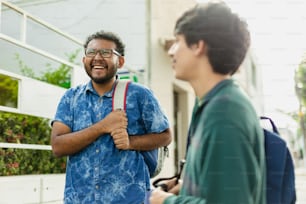 two men standing next to each other talking