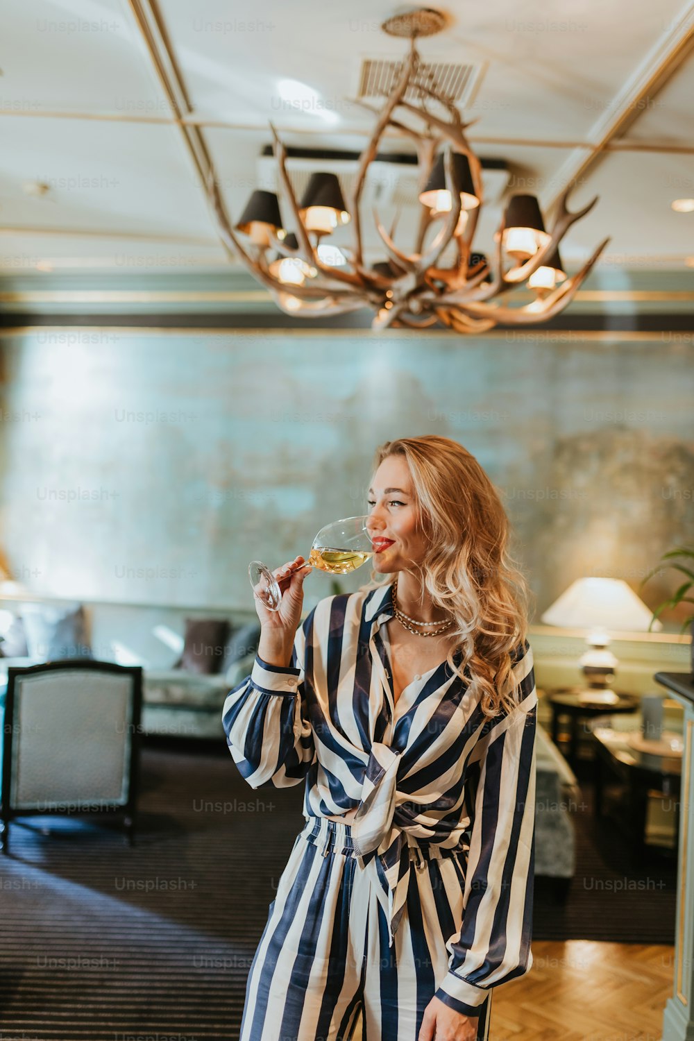 a woman standing in a room eating food