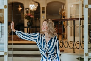 a woman standing in front of a glass door