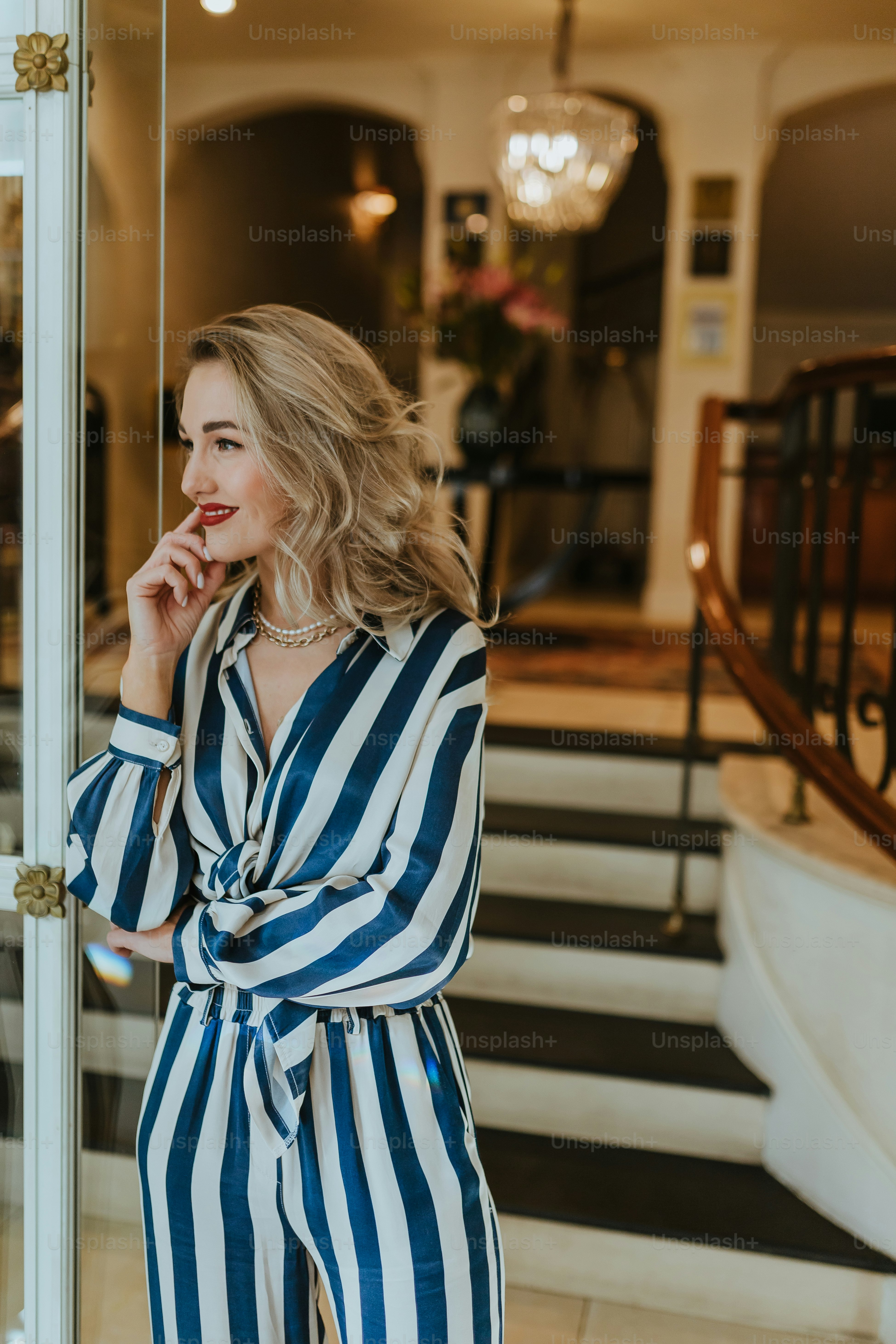 a woman in a blue and white striped jumpsuit