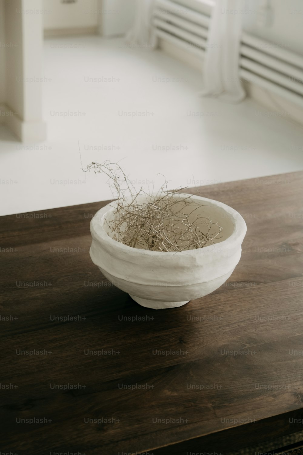 a white bowl sitting on top of a wooden table