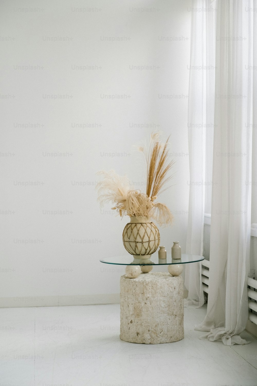 a glass table with a vase on top of it