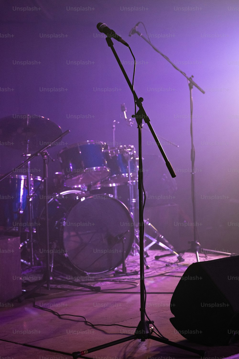 a microphone and drums on a stage