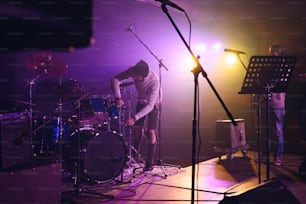 a band playing on a stage with microphones