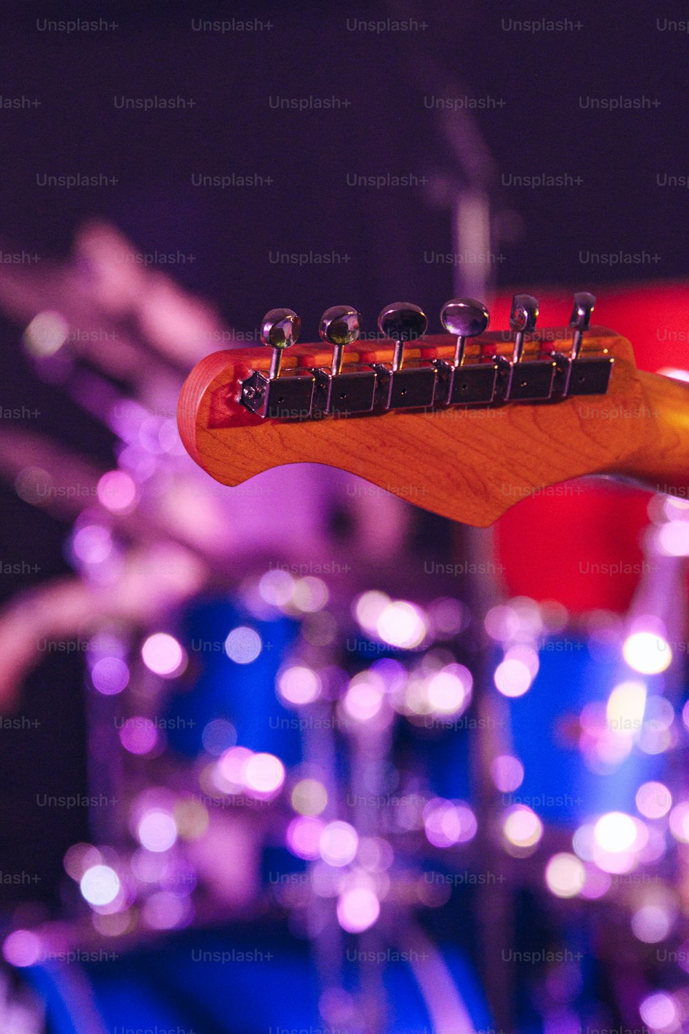 a close up of a guitar neck on a stage