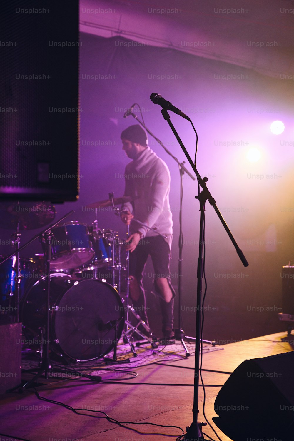 a man standing next to a microphone on a stage