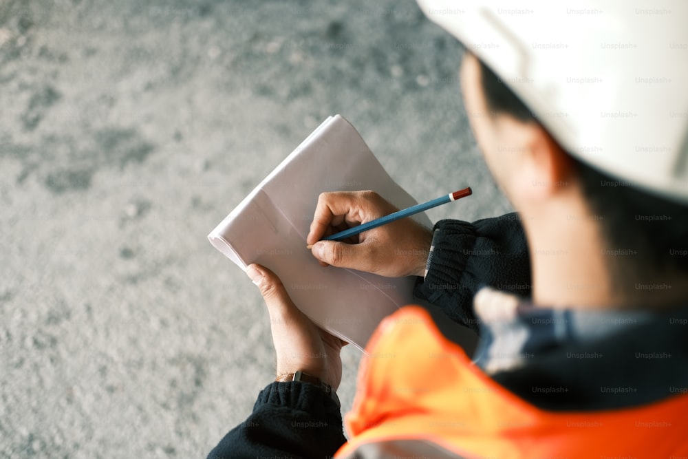 a construction worker writing on a piece of paper