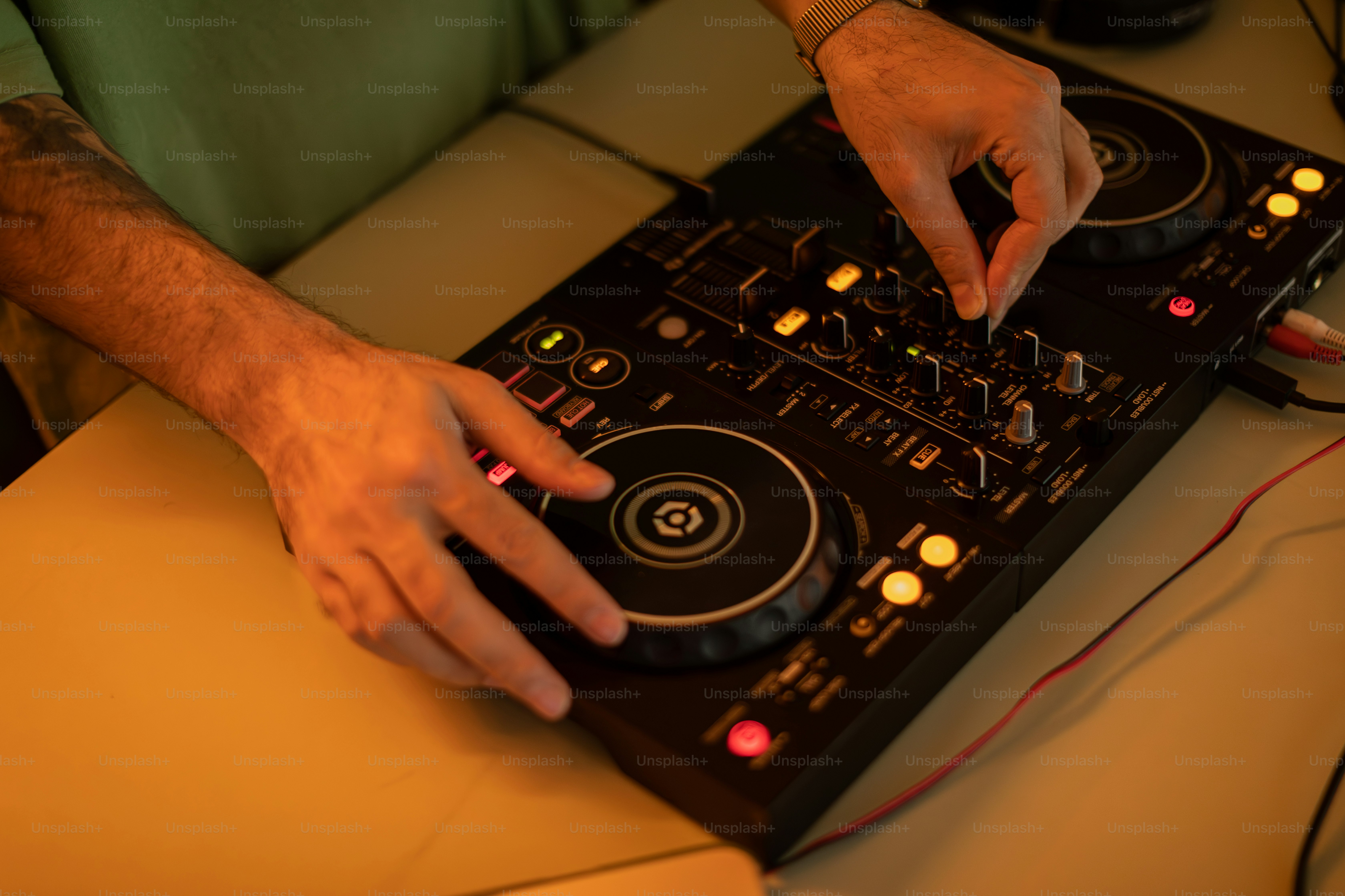 a man is using a dj controller on a table