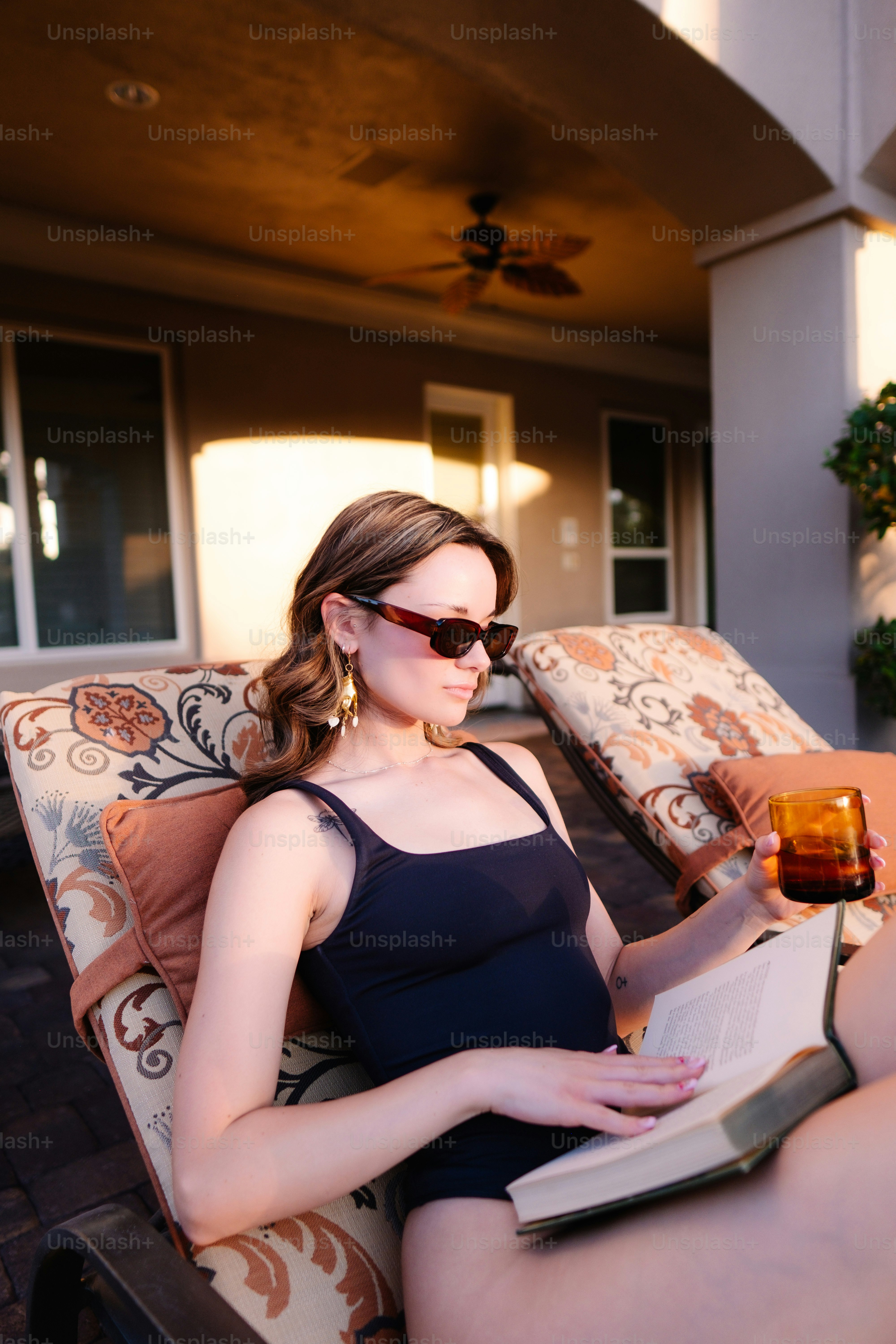 a woman sitting in a chair reading a book
