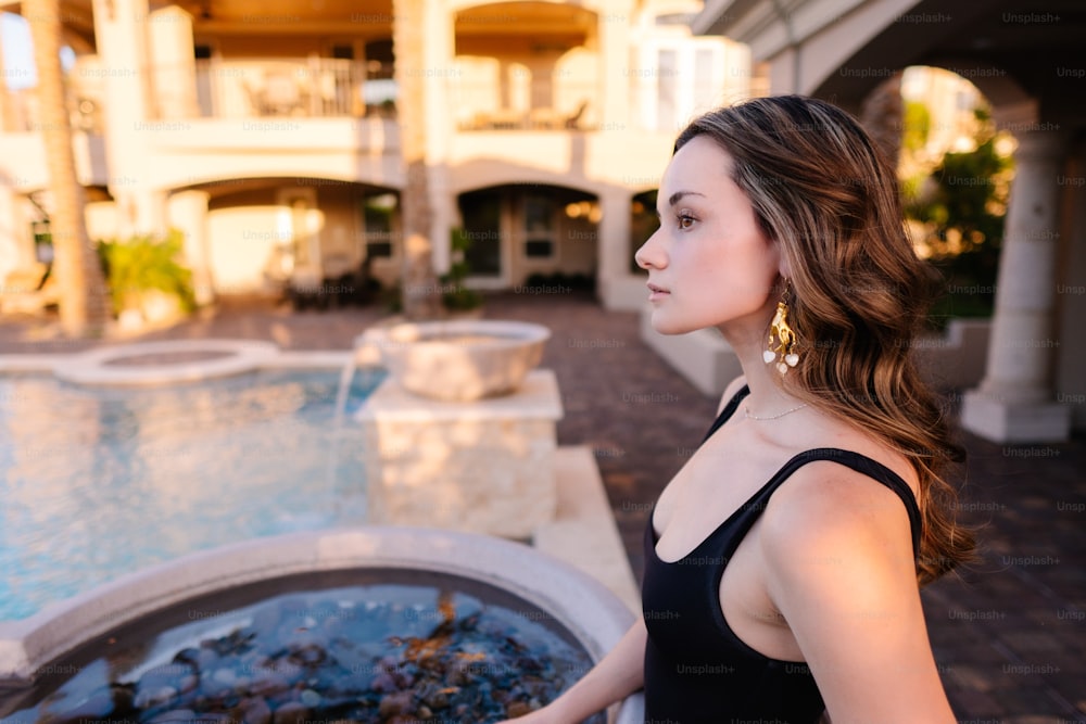 a woman standing in front of a fountain