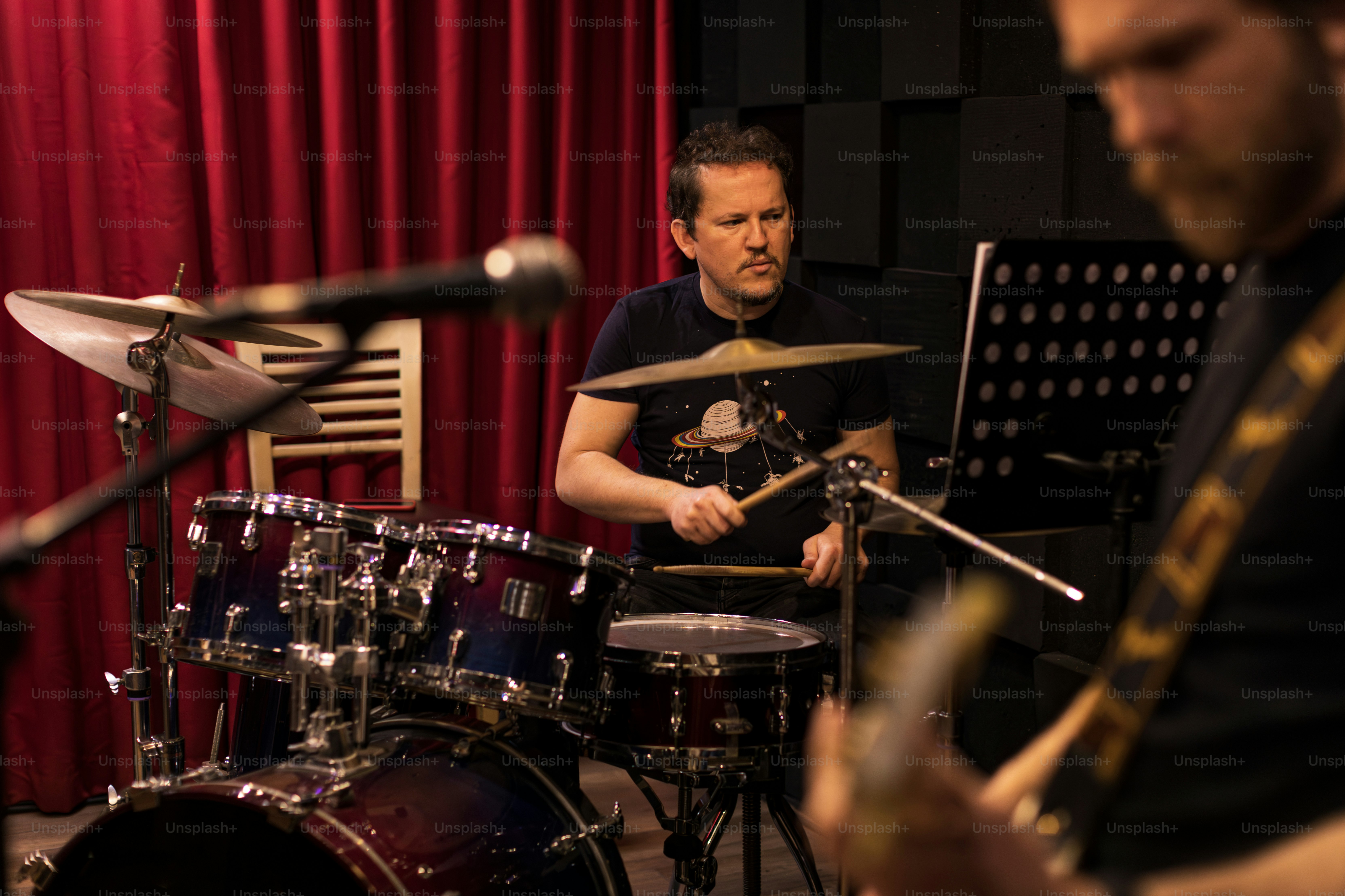a man playing drums in a recording studio