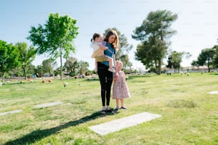 a woman holding a child in a park