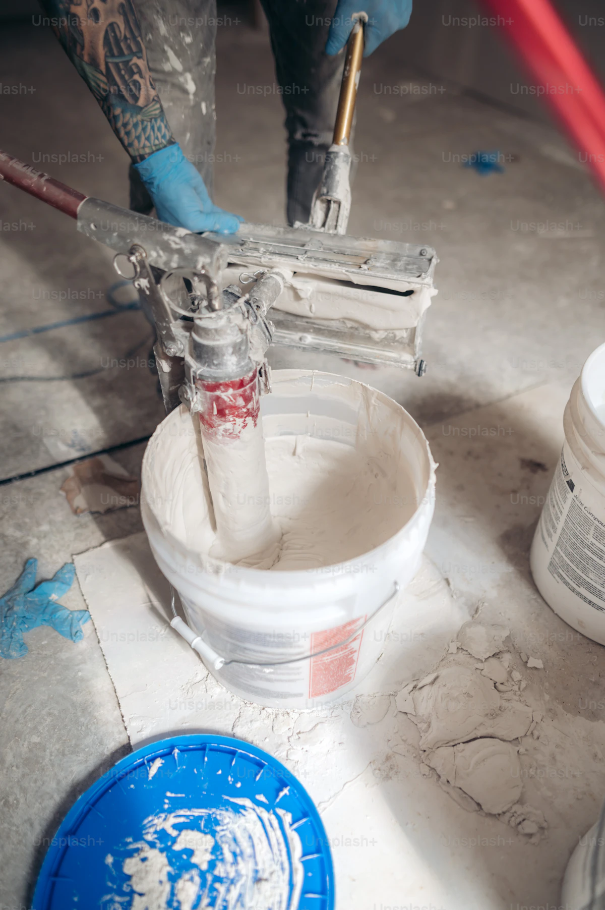 Professional concrete surface preparation and construction site showing floor treatment and industrial cleaning work