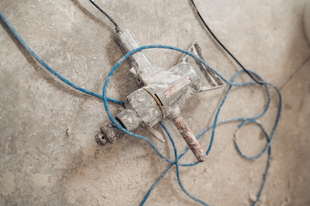 a broken glass bottle sitting on top of a cement floor