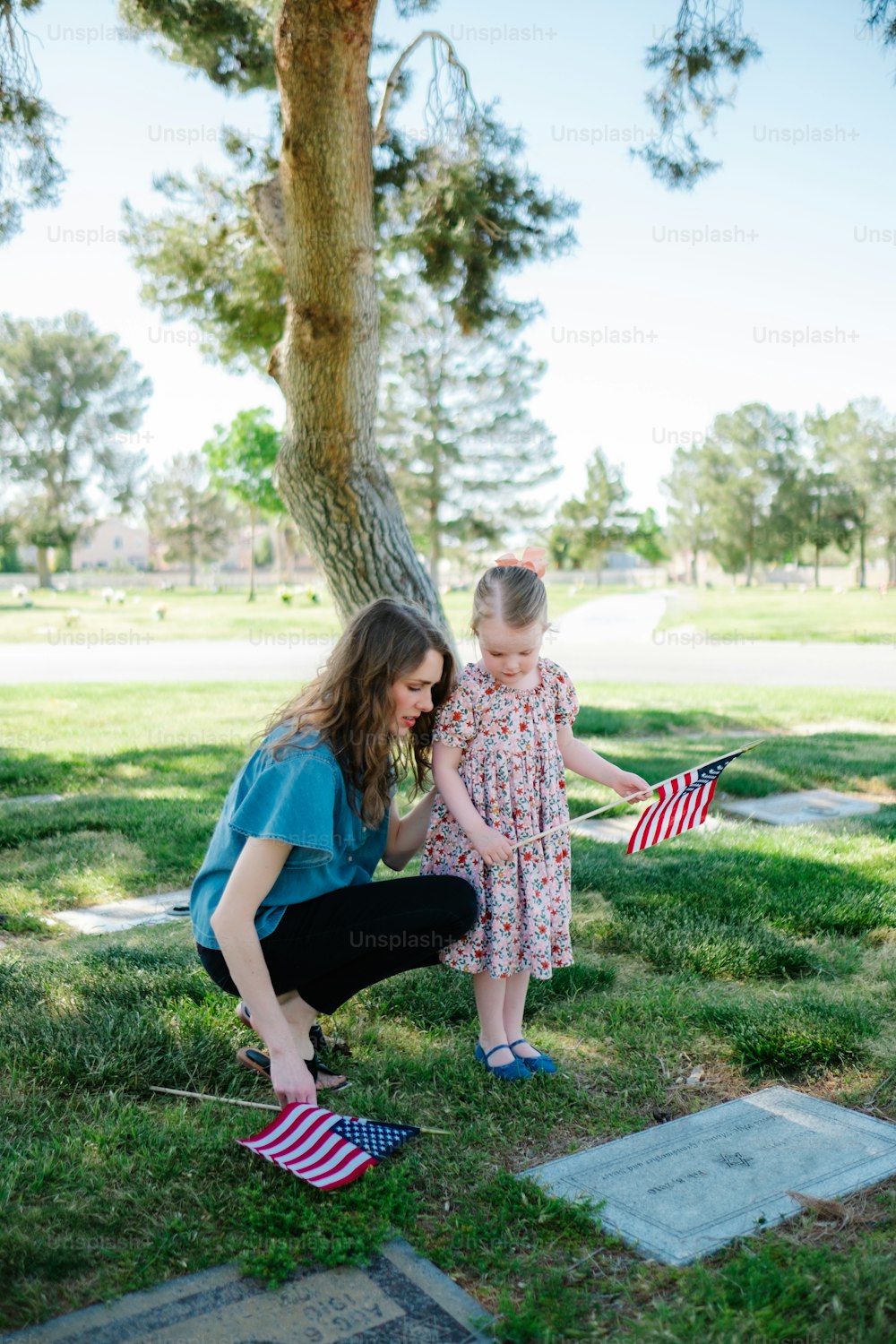 a woman and a child holding a flag