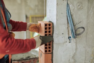 a person working on a wall with a hammer