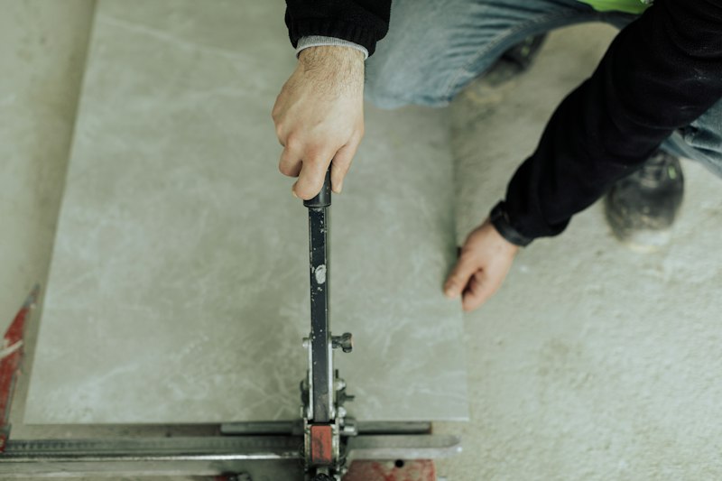 Professional tile repair during commercial building maintenance visit