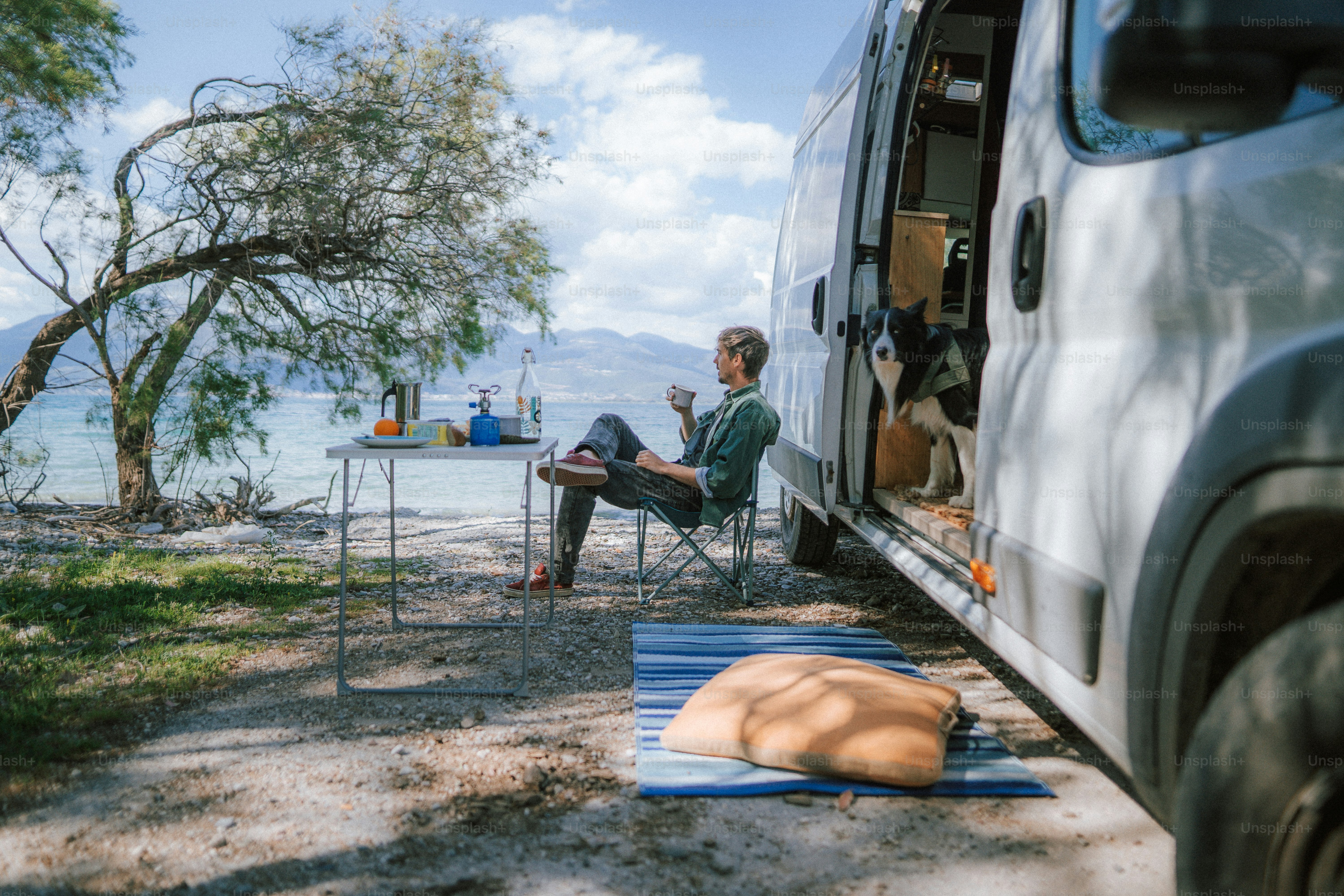 a man sitting in a chair next to a van