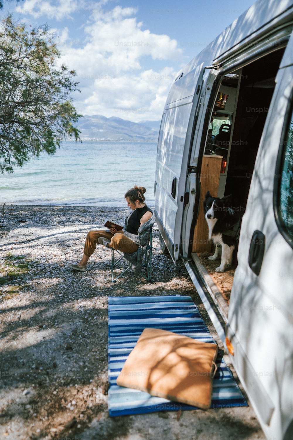 a woman sitting in a chair next to a van