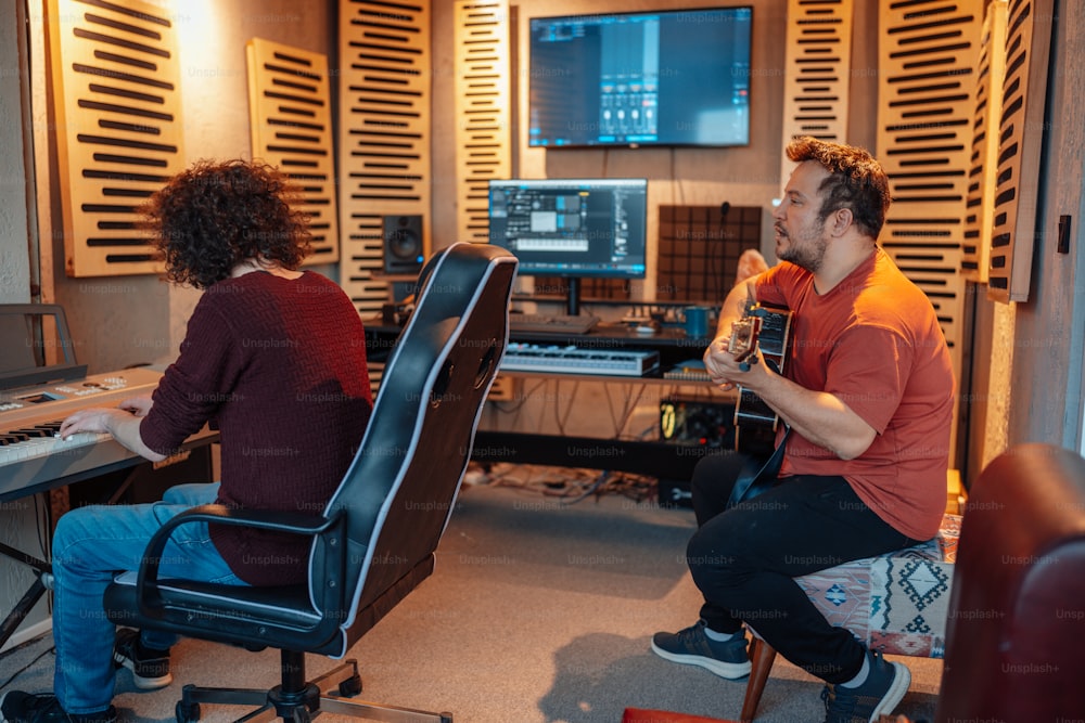 a man and a woman sitting in front of a computer