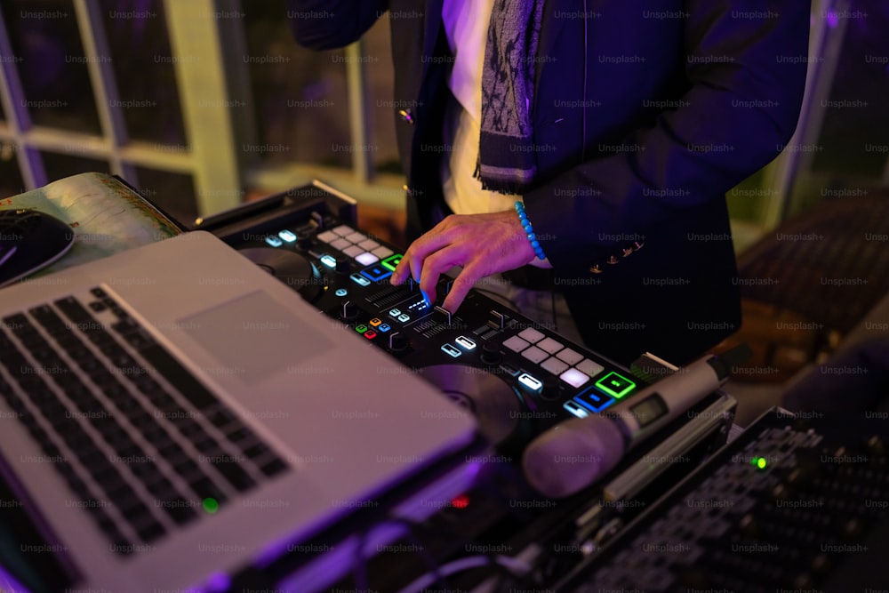 a dj mixing music on a laptop computer