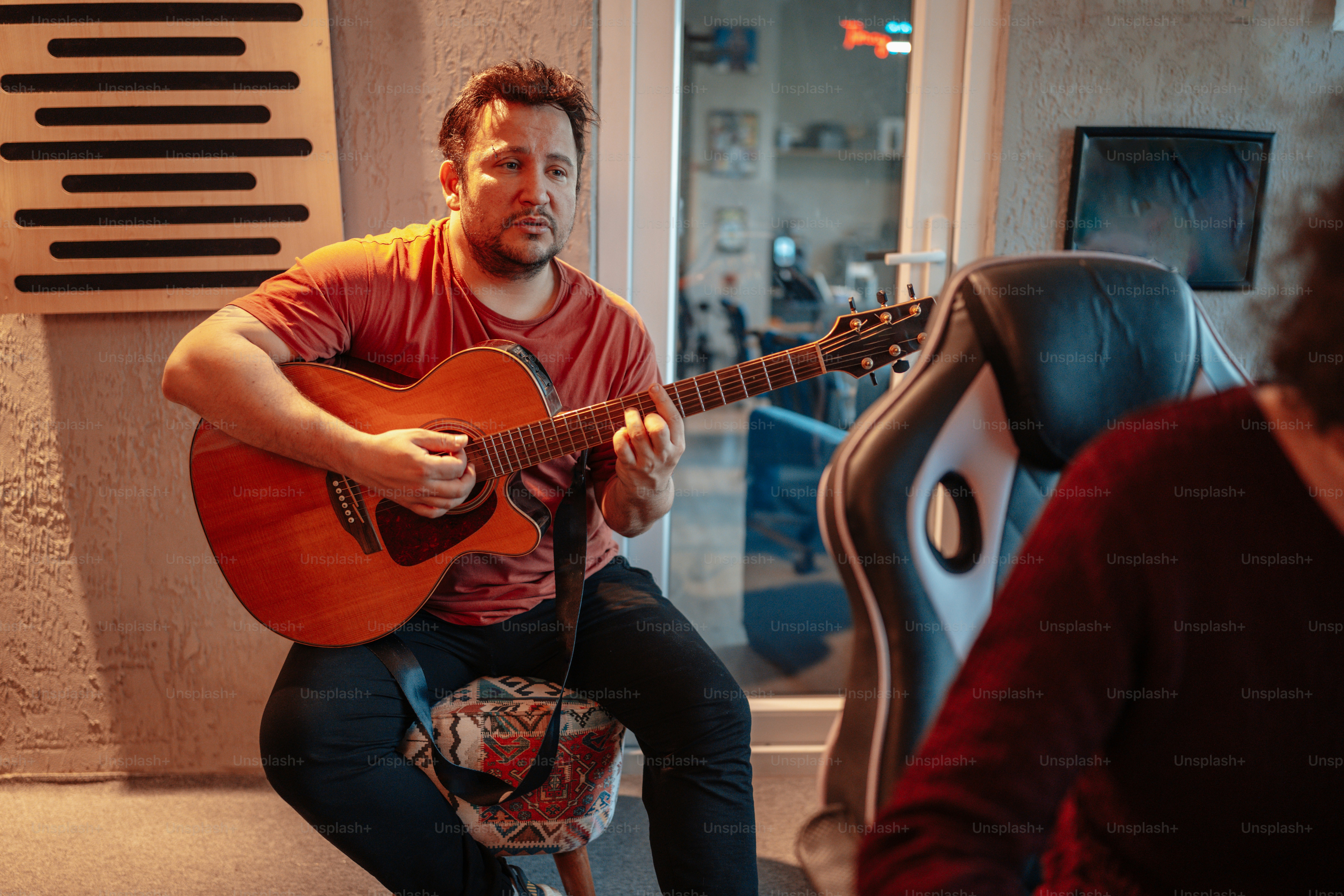 A man sitting on a chair playing a guitar photo – Music Image on Unsplash
