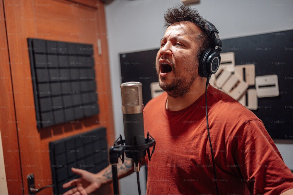 Ein Mann, der in einem Aufnahmestudio in ein Mikrofon singt