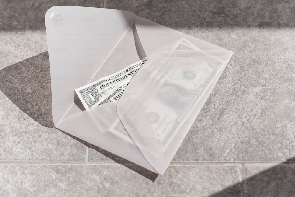 a white envelope with money sticking out of it