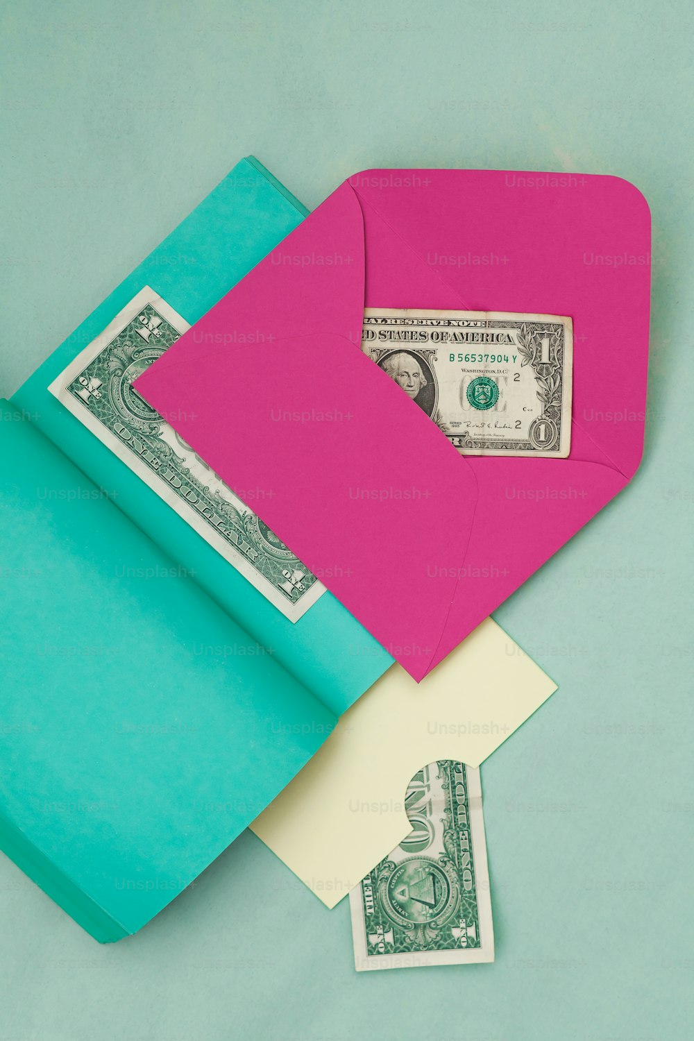 a pink envelope with a dollar bill sticking out of it