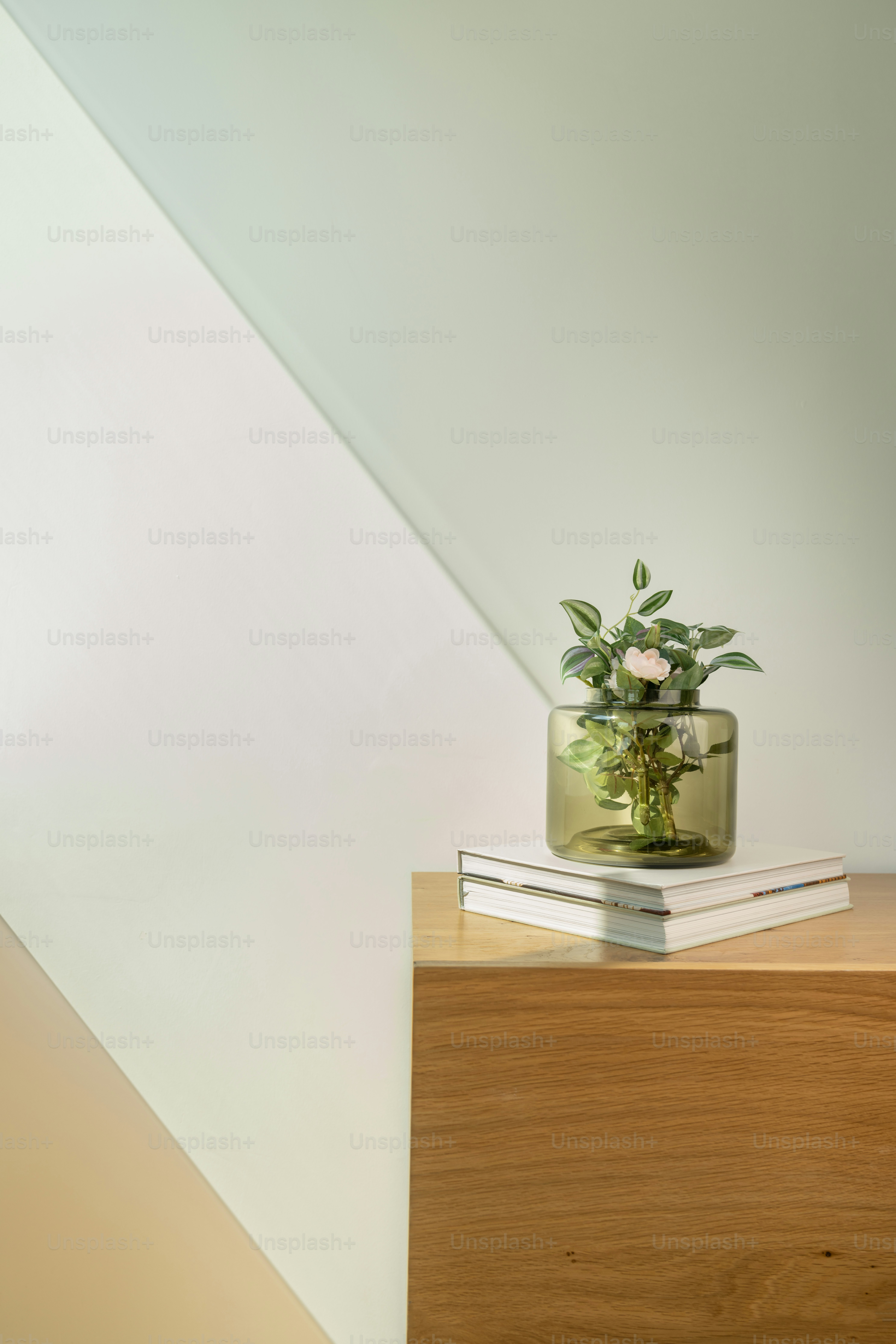 a vase with flowers sitting on top of a wooden table