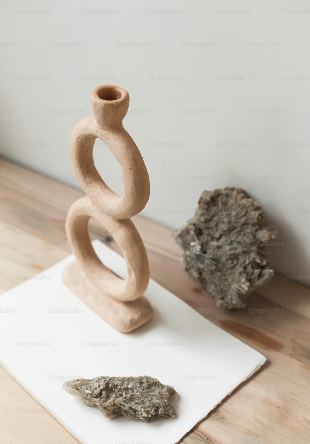 a rock and a sculpture on a table