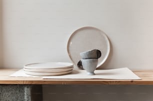 a stack of plates sitting on top of a wooden table