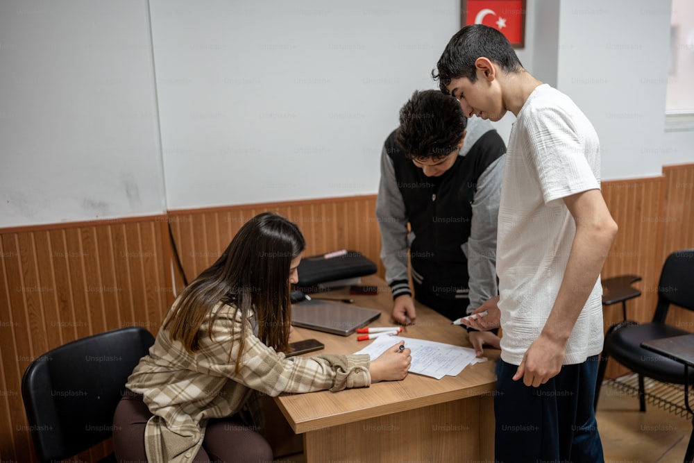 a group of people standing around a wooden table