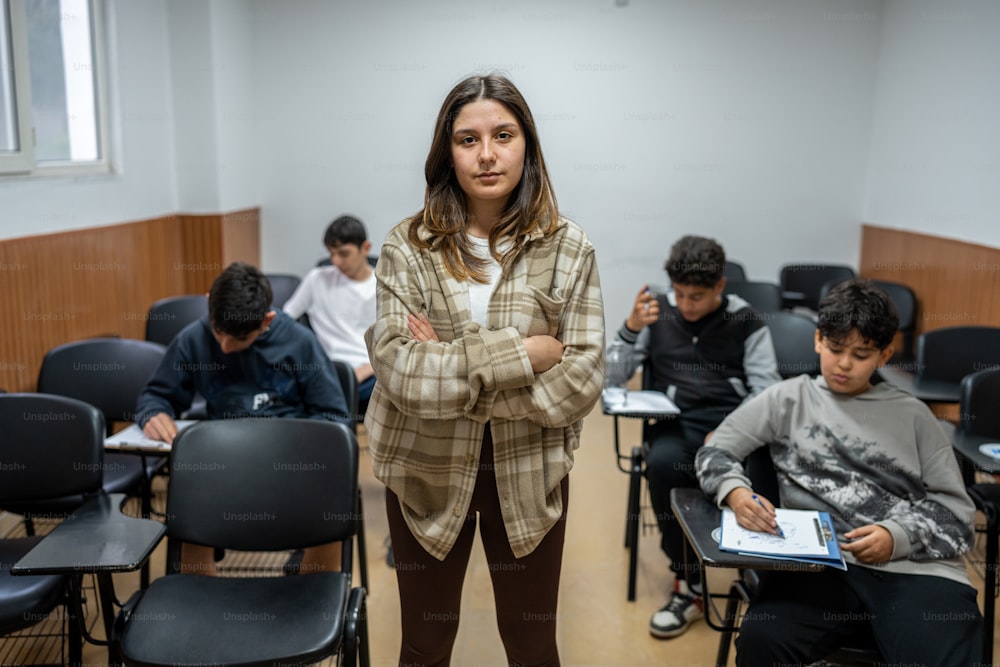 a woman standing in front of a classroom full of students