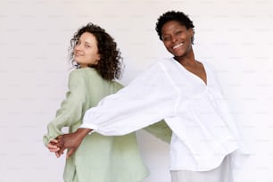 two women standing next to each other with their arms around each other